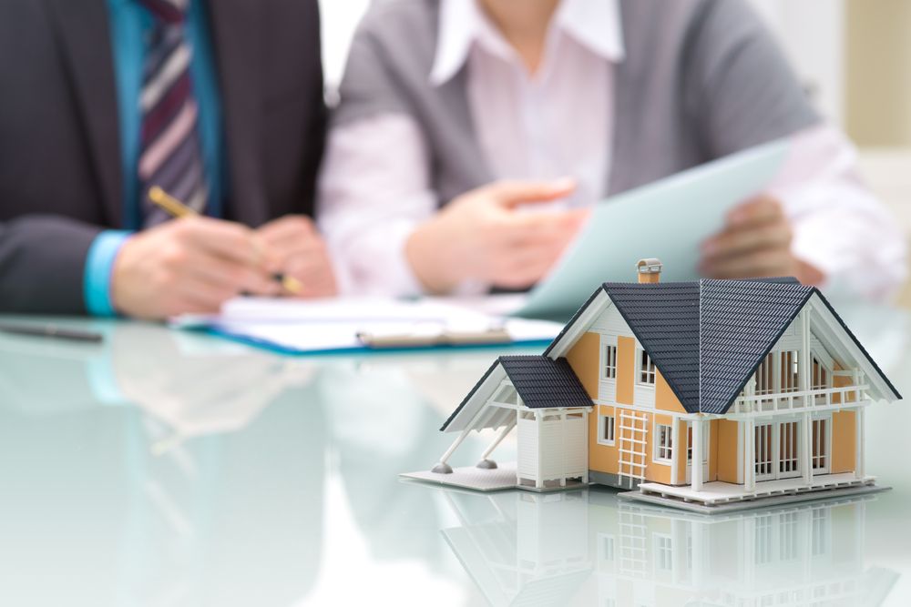 Model House with insurance agents behind